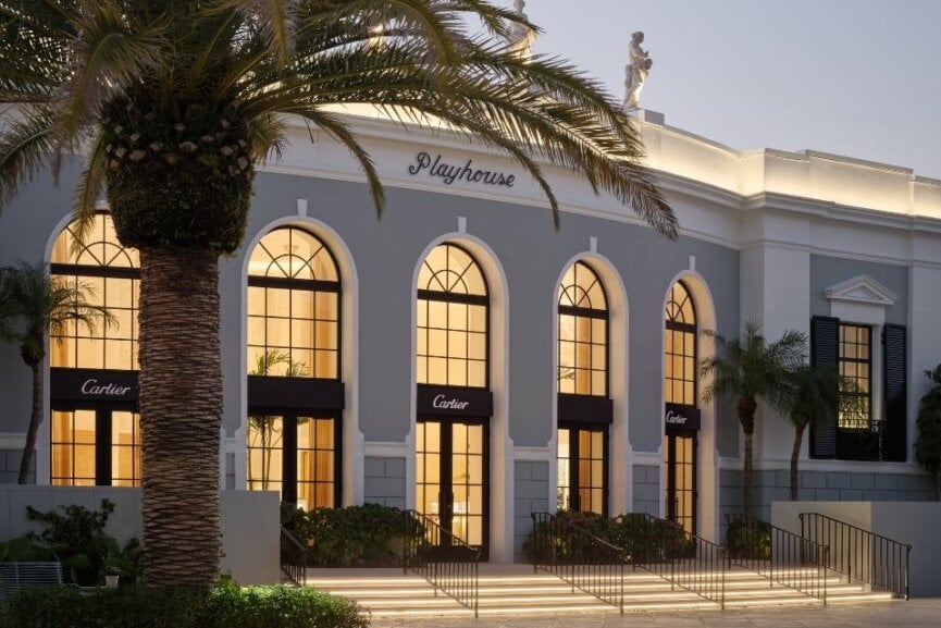 exterior shot of the Cartier boutique at The Playhouse big windows, plams, night with windows lit up